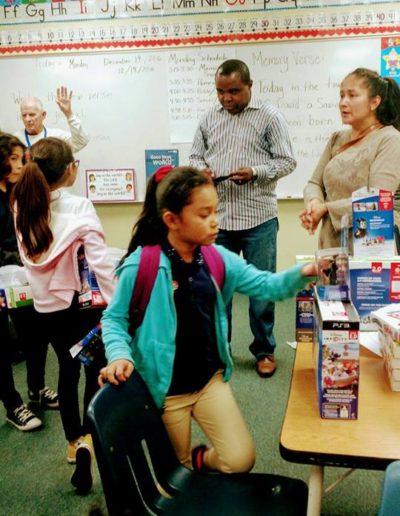 Kids in the classroom checking the toy boxes