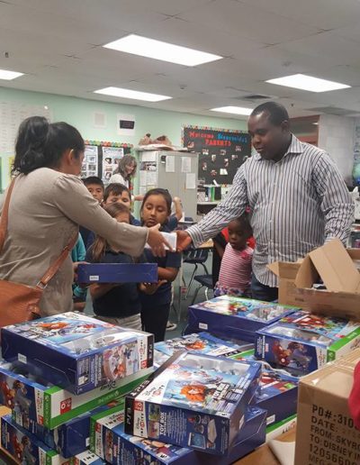 Adults giving toys to the kids