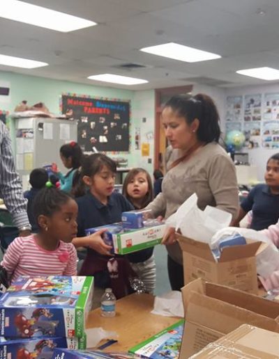 Adults giving out the toys to the kids