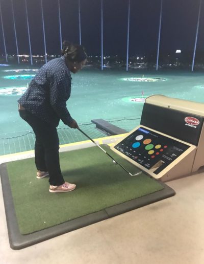 A woman testing her swing with the golf club