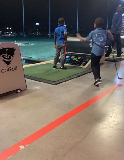 Two boys playing golf