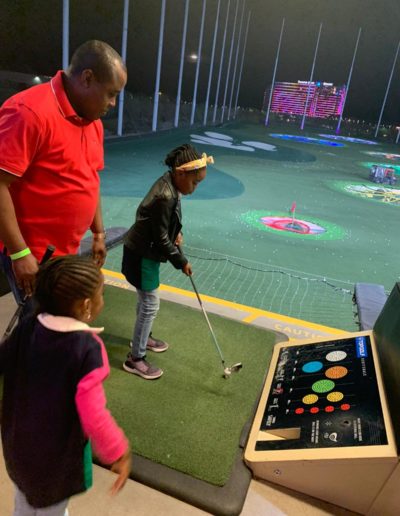 A girl estimating her swing at the golf ball