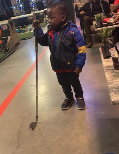 A young boy holding a golf club