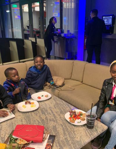 A group of kids having snacks at the lounge area